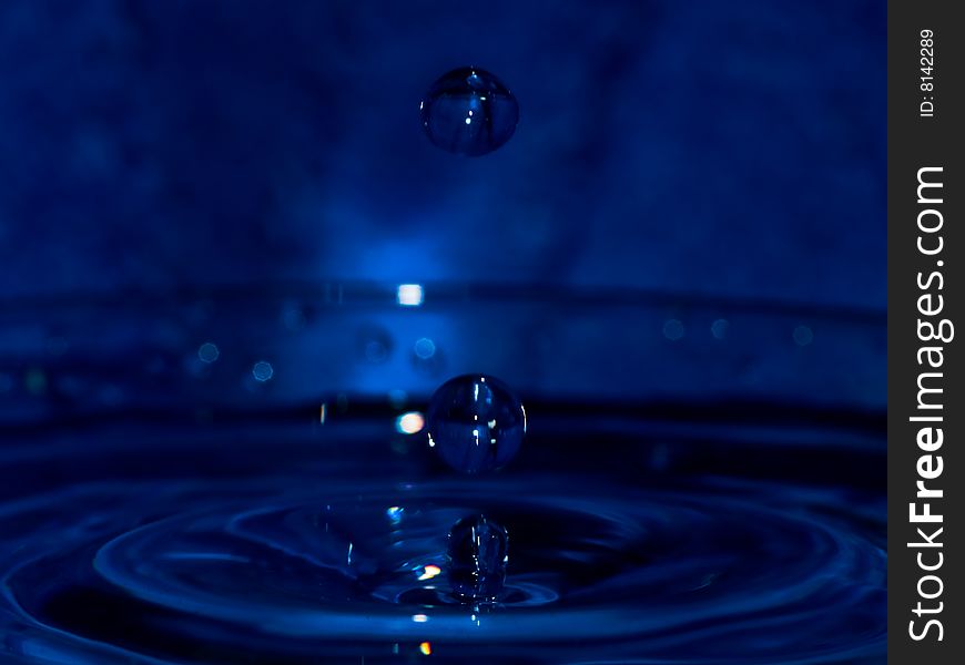 Water drop on dark blue background