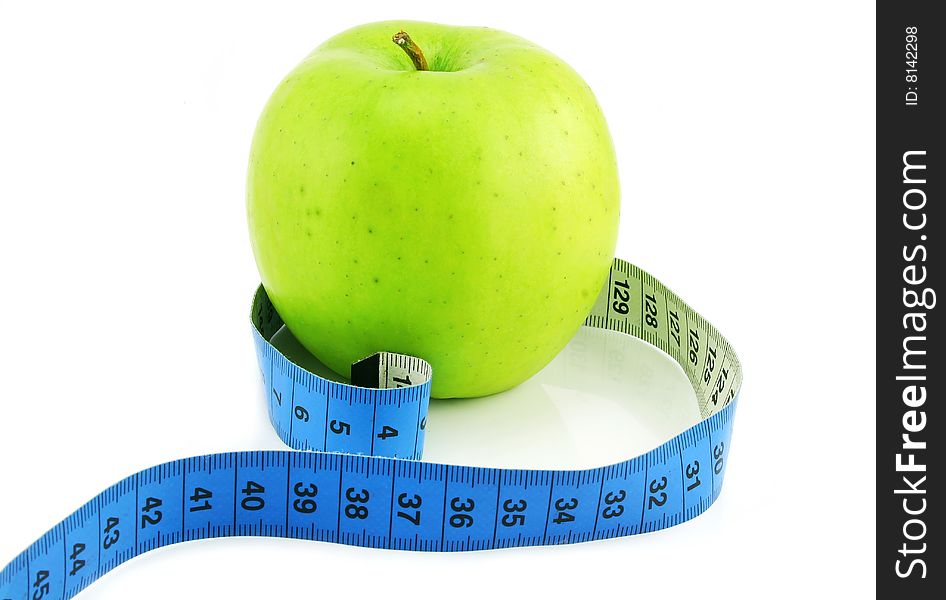 Bright green apple and measuring tape isolated on a white background