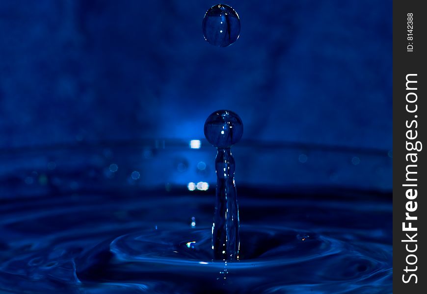 Water drop on dark blue background
