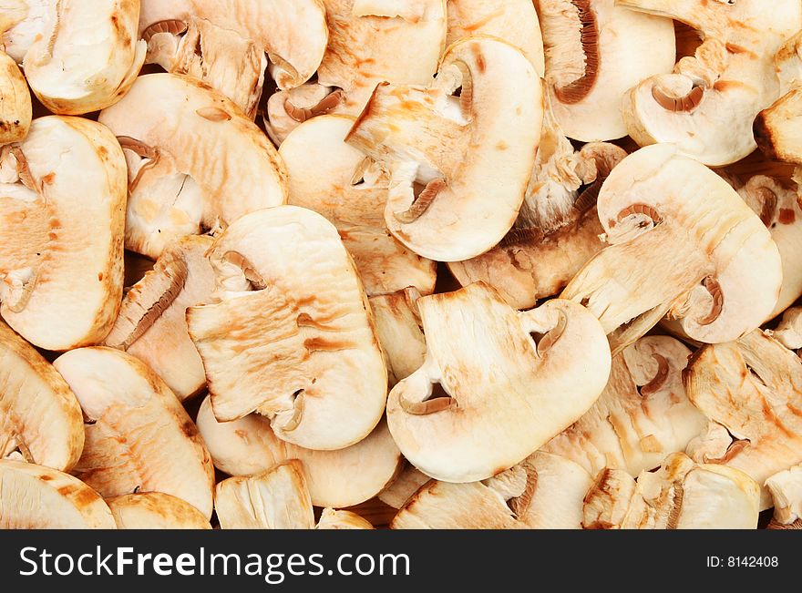 Sliced button mushrooms as a background and texture. Sliced button mushrooms as a background and texture