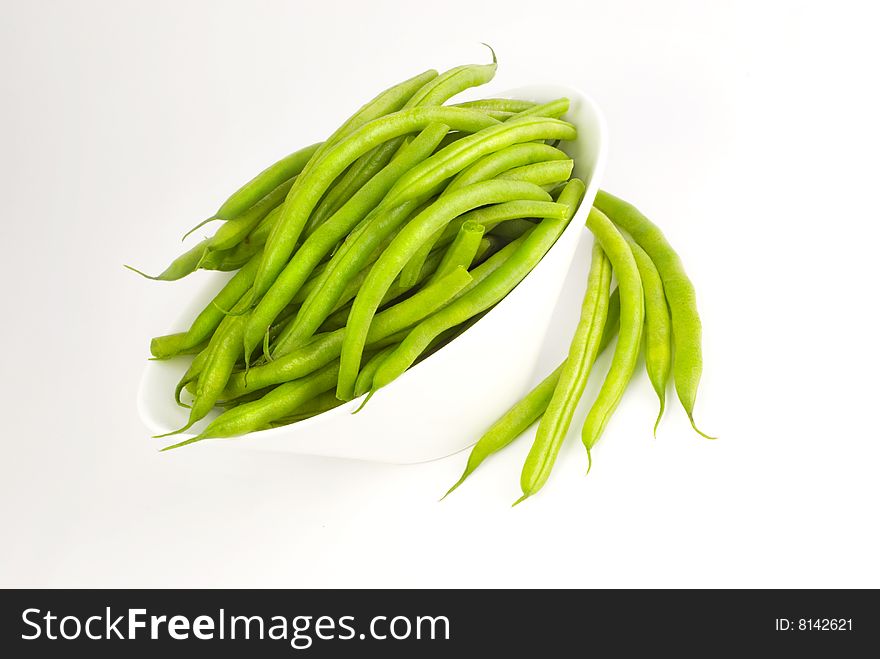 Fresh whole green beans in a white bowl isolated with copy space. Fresh whole green beans in a white bowl isolated with copy space