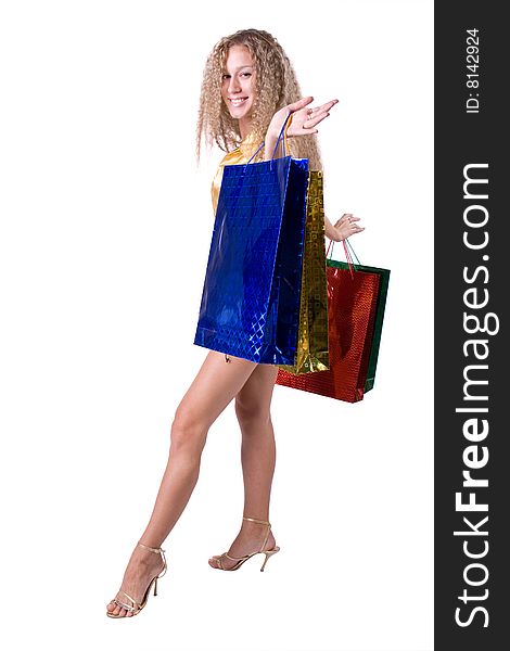 The young beautiful girl with purchases in colour packages during shopping on a white background. The young beautiful girl with purchases in colour packages during shopping on a white background