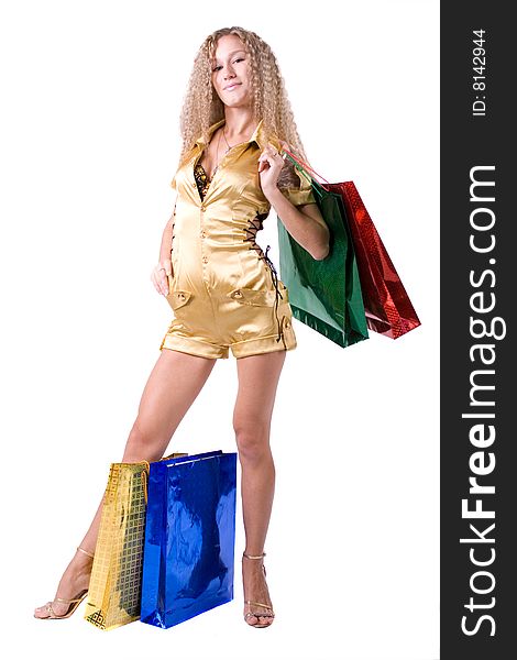 The young beautiful girl with purchases in colour packages during shopping on a white background. The young beautiful girl with purchases in colour packages during shopping on a white background