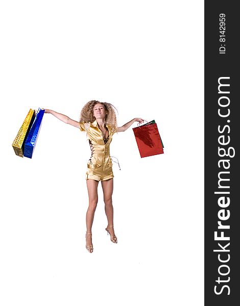 The young beautiful girl with purchases in colour packages during shopping on a white background. The young beautiful girl with purchases in colour packages during shopping on a white background