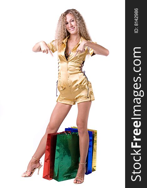 The young beautiful girl with purchases in colour packages during shopping on a white background. The young beautiful girl with purchases in colour packages during shopping on a white background