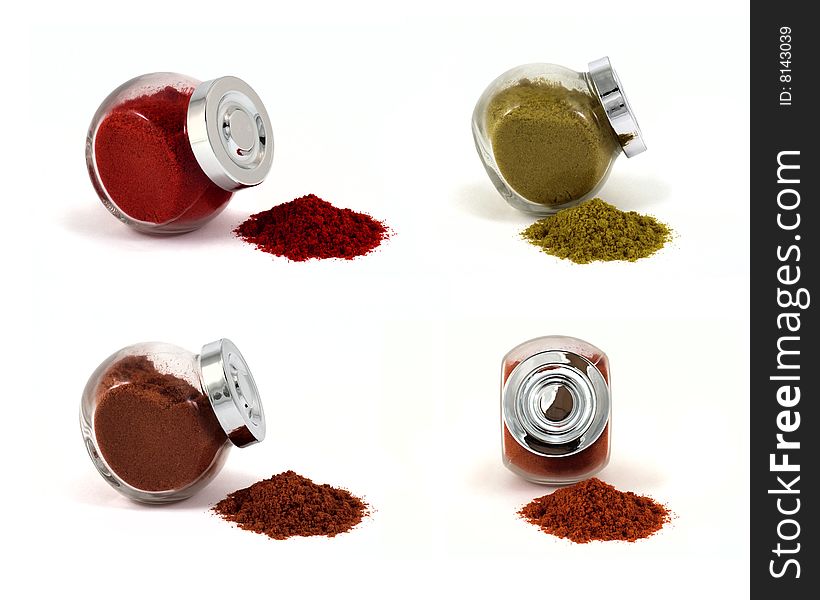 Four jars with spices on isolated white background, focus at jars caps