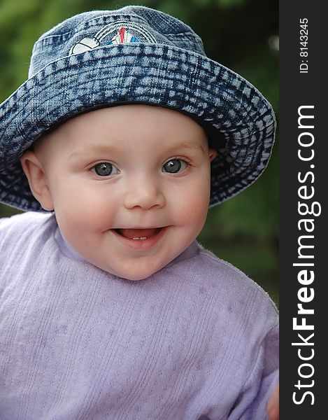 Baby Smiled in blue jean hat