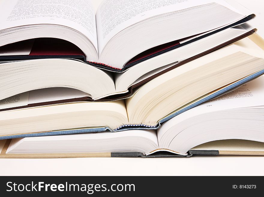 Stack of opened text books on a white background. Stack of opened text books on a white background.