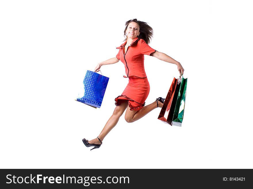 The young beautiful girl with purchases in colour packages during shopping on a white background. The young beautiful girl with purchases in colour packages during shopping on a white background