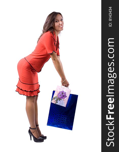 The young beautiful girl with purchases in colour packages during shopping on a white background. The young beautiful girl with purchases in colour packages during shopping on a white background