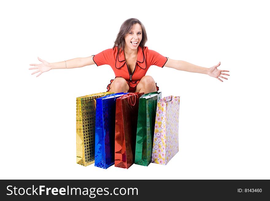 The young beautiful girl with purchases in colour packages during shopping on a white background. The young beautiful girl with purchases in colour packages during shopping on a white background