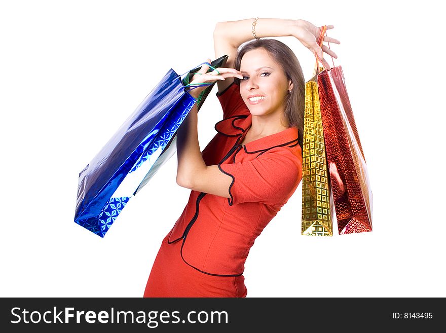 The young beautiful girl with purchases in colour packages during shopping on a white background. The young beautiful girl with purchases in colour packages during shopping on a white background