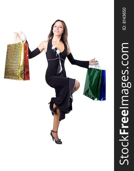 The young beautiful girl with purchases in colour packages during shopping on a white background. The young beautiful girl with purchases in colour packages during shopping on a white background