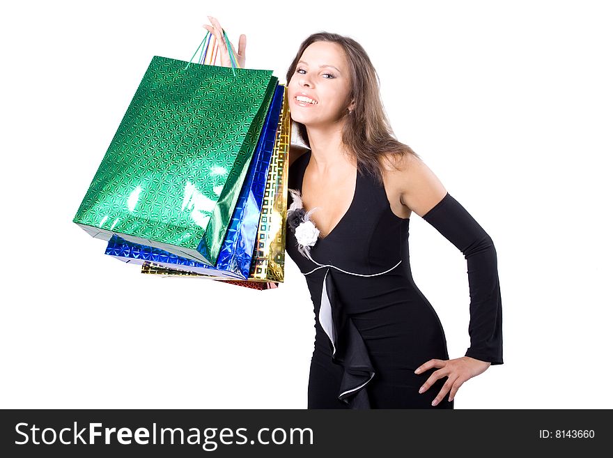 The young beautiful girl with purchases in colour packages during shopping on a white background. The young beautiful girl with purchases in colour packages during shopping on a white background