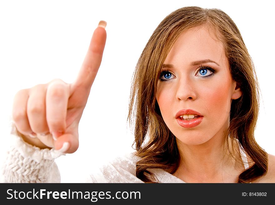 Portrait of young female pointing up on an isolated white background