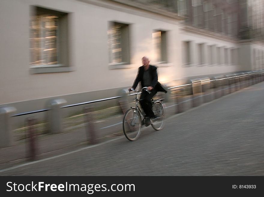 Man with halo riding his bike on the streets of Amsterdam . Man with halo riding his bike on the streets of Amsterdam