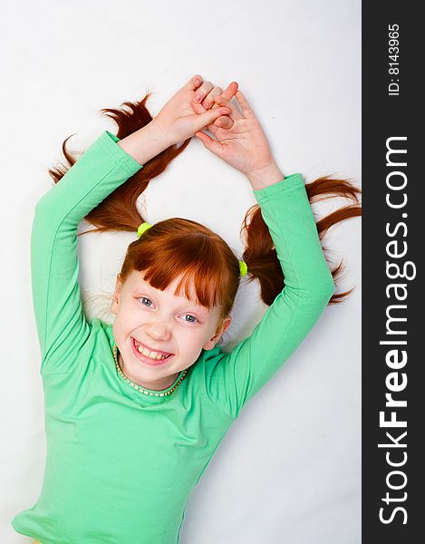 A red girl smiles. Photo on a white background. A red girl smiles. Photo on a white background.