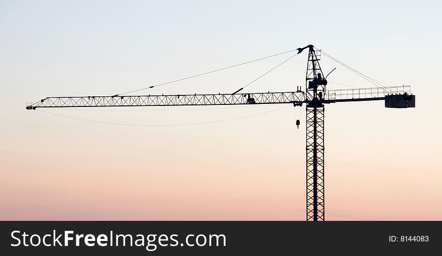 Crane on the sunset background. Crane on the sunset background