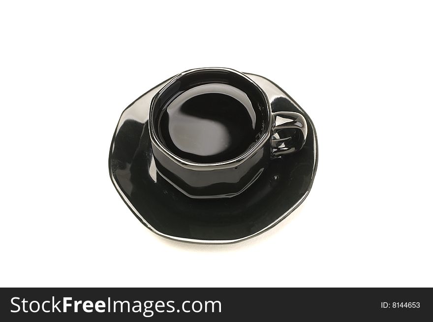 Black demmitasse cup full of espresso on white. Black demmitasse cup full of espresso on white