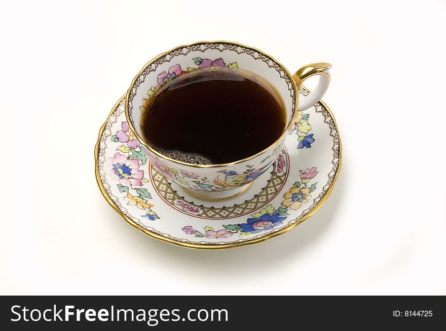 Ornate china cup of coffee on a white background. Ornate china cup of coffee on a white background
