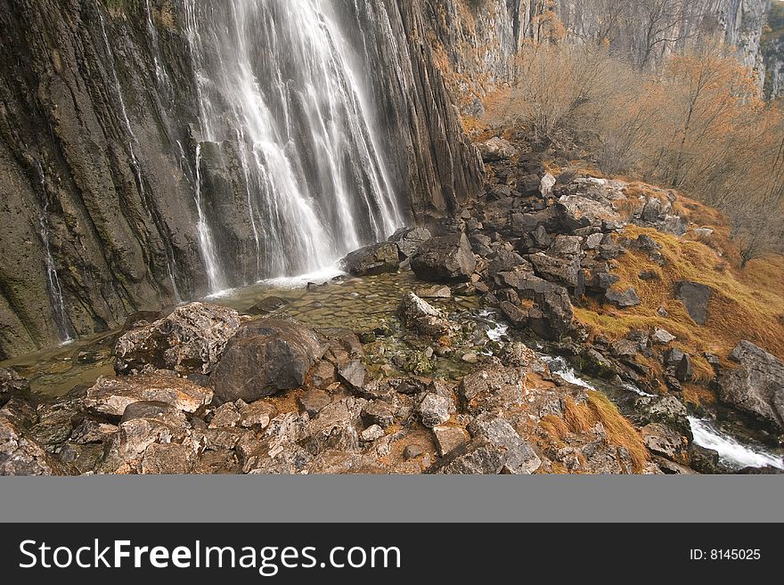 The beautiful waterfall in the forest, autumn (long exposure)