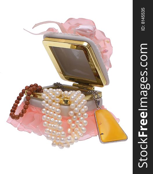 Open box with beads and pearls on a white background. Open box with beads and pearls on a white background.