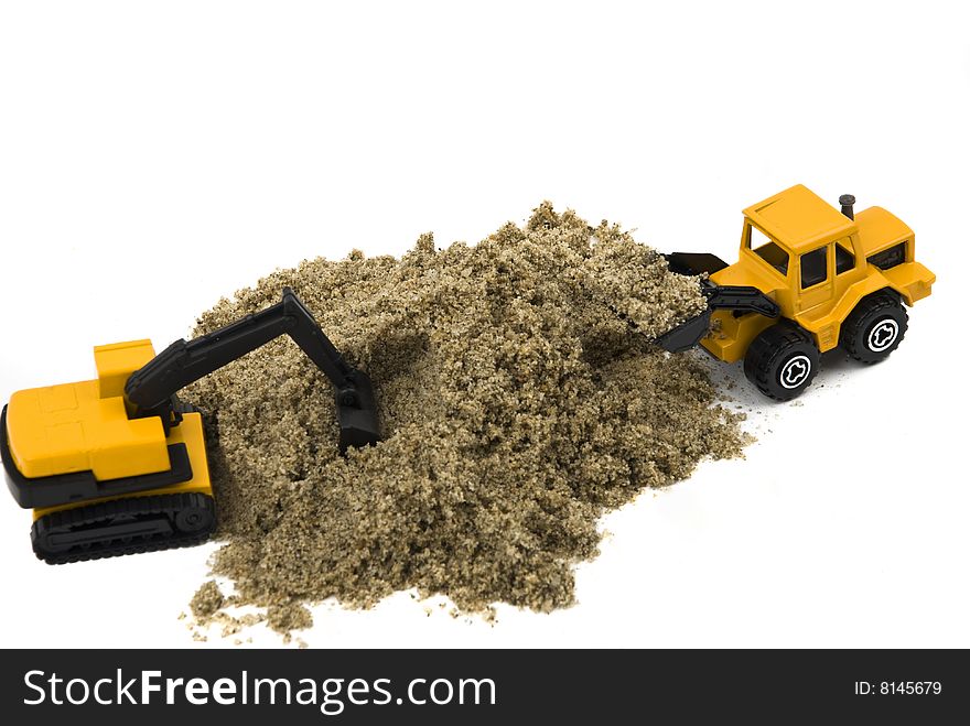 Two yellow trucks toy working in sand isolated on white background.Also,check out Workers and tools