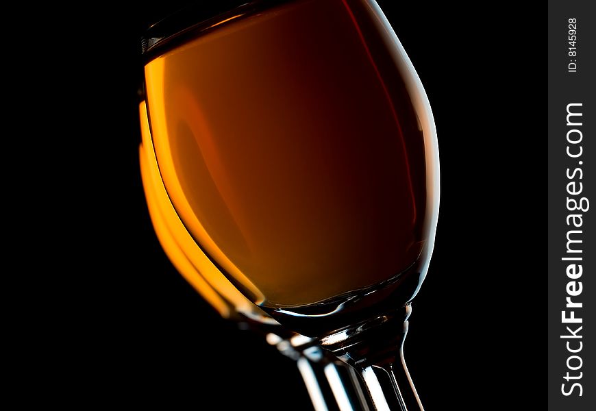 Three small glasses filled with orange liquor on black background. Three small glasses filled with orange liquor on black background