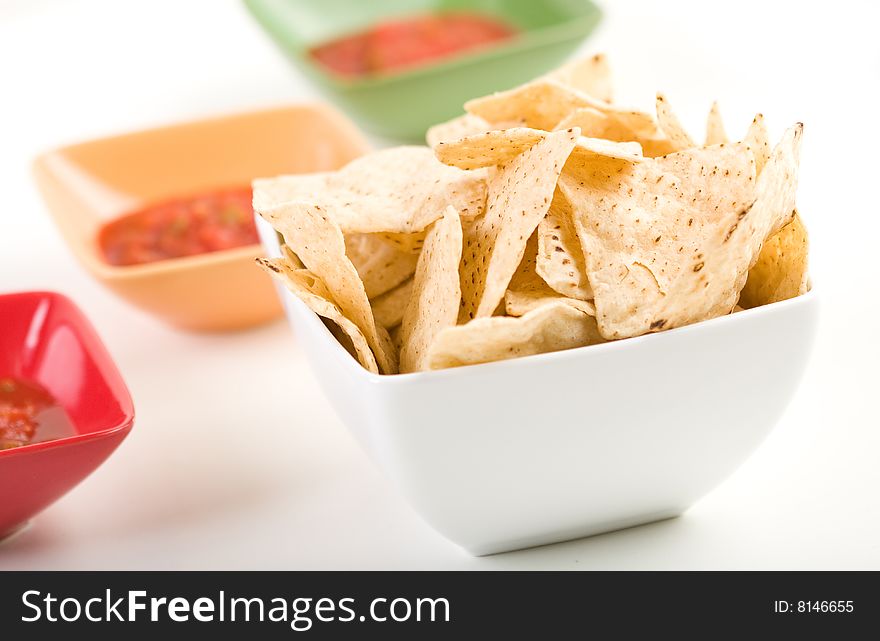 Tortilla chips with salsa in colorful bowls. Tortilla chips with salsa in colorful bowls