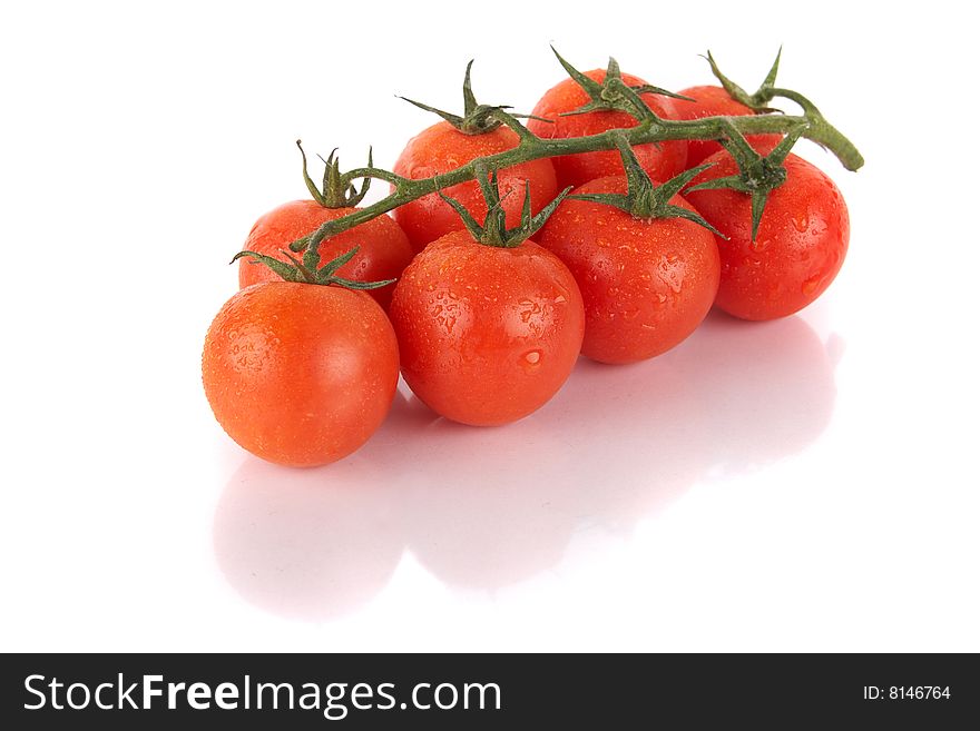 Macroshot of a bunch of tomatoes with dropd of water. Isolated over white background. Lot of copyspace. Macroshot of a bunch of tomatoes with dropd of water. Isolated over white background. Lot of copyspace.