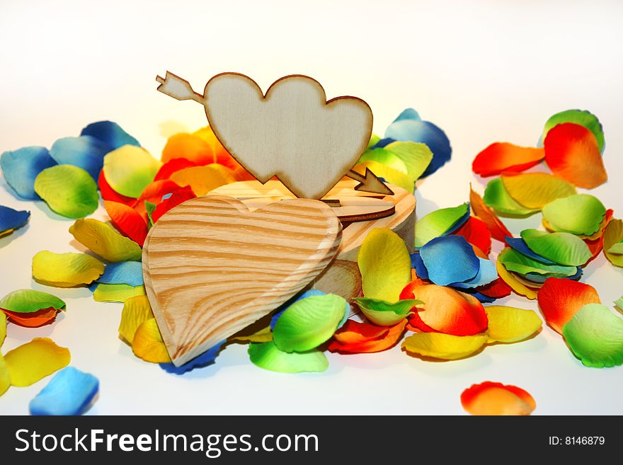 Wood heart box with colored flower petals. Wood heart box with colored flower petals