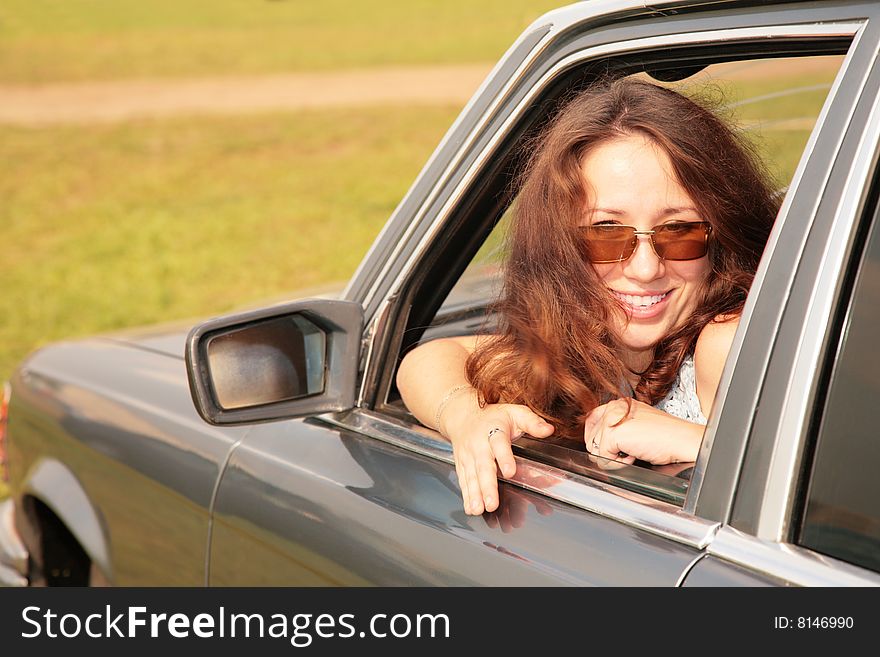 Woman Smiles In A Car Window