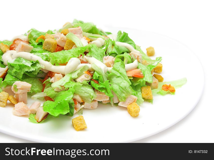 Caesar salad with chicken on white background