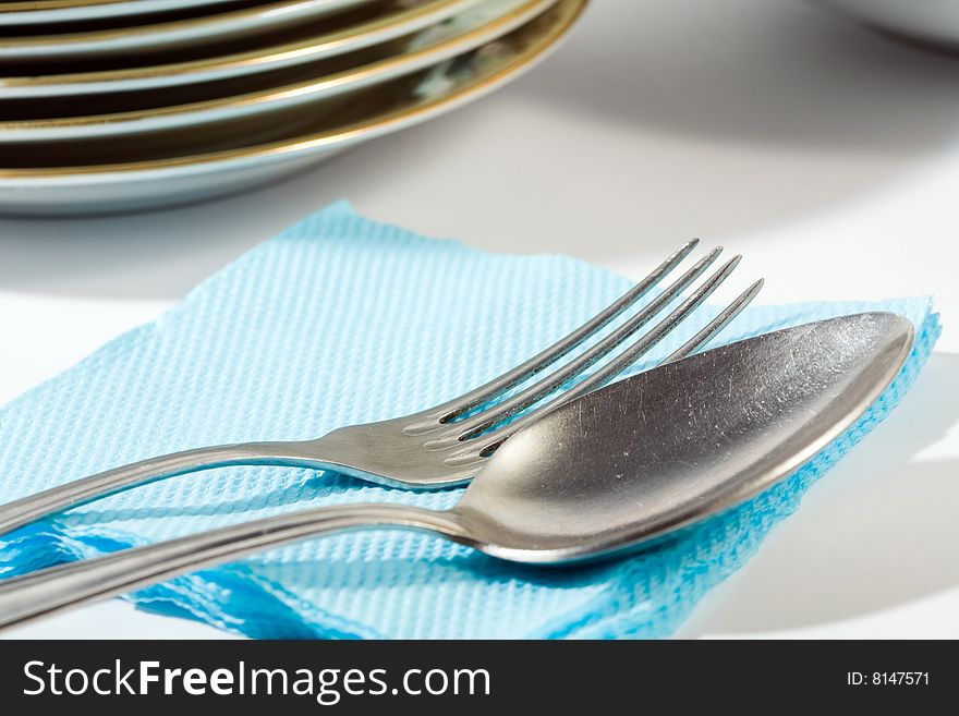 Stock photo: an image of a spoon and a fork on blue napkin. Stock photo: an image of a spoon and a fork on blue napkin