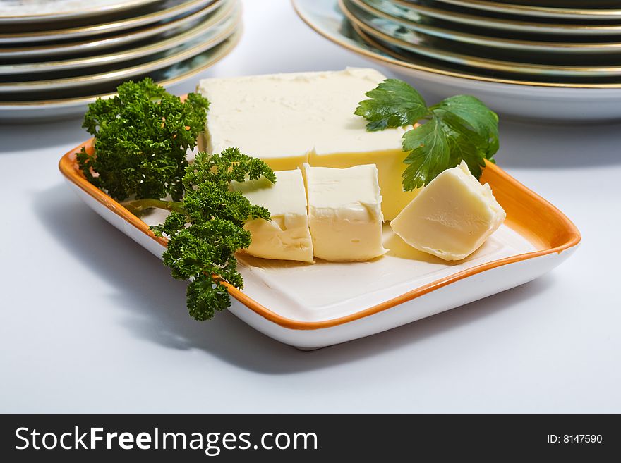 Stock photo: an image of butter and  parsley on a plate. Stock photo: an image of butter and  parsley on a plate