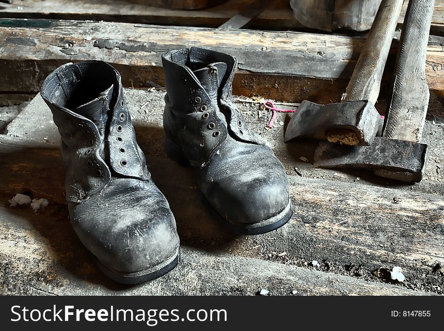 Stock photo: an image of old black dirty boots and ax