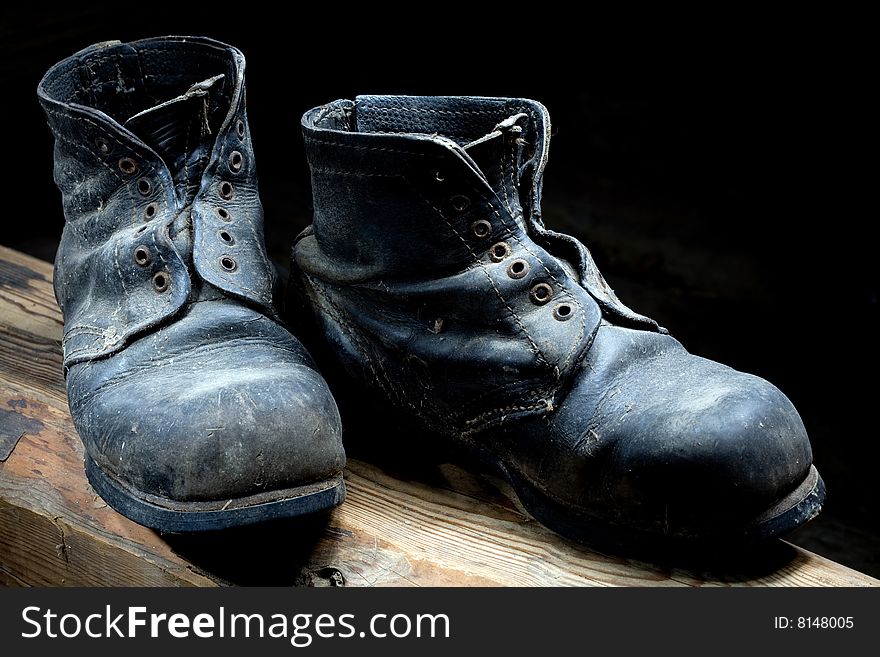 Stock photo: an image of very old black boots closeup. Stock photo: an image of very old black boots closeup