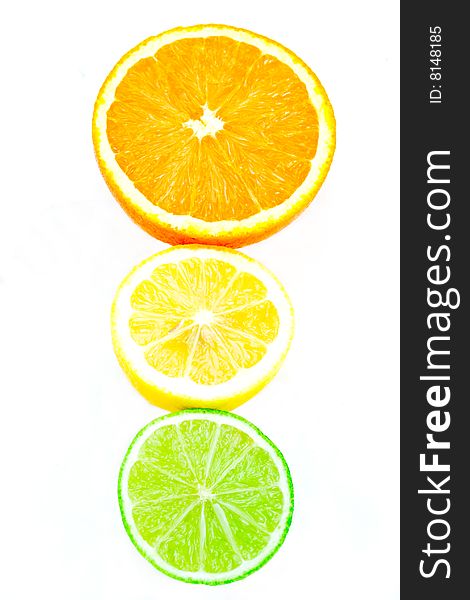 A traffic light formation of citrus fruits on white. A traffic light formation of citrus fruits on white