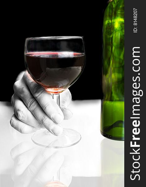 Hand holding red wine glass with bottle. Hand holding red wine glass with bottle
