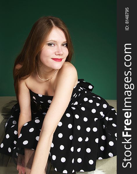 Smiling young woman whith long red hair in polkadot dress. Smiling young woman whith long red hair in polkadot dress