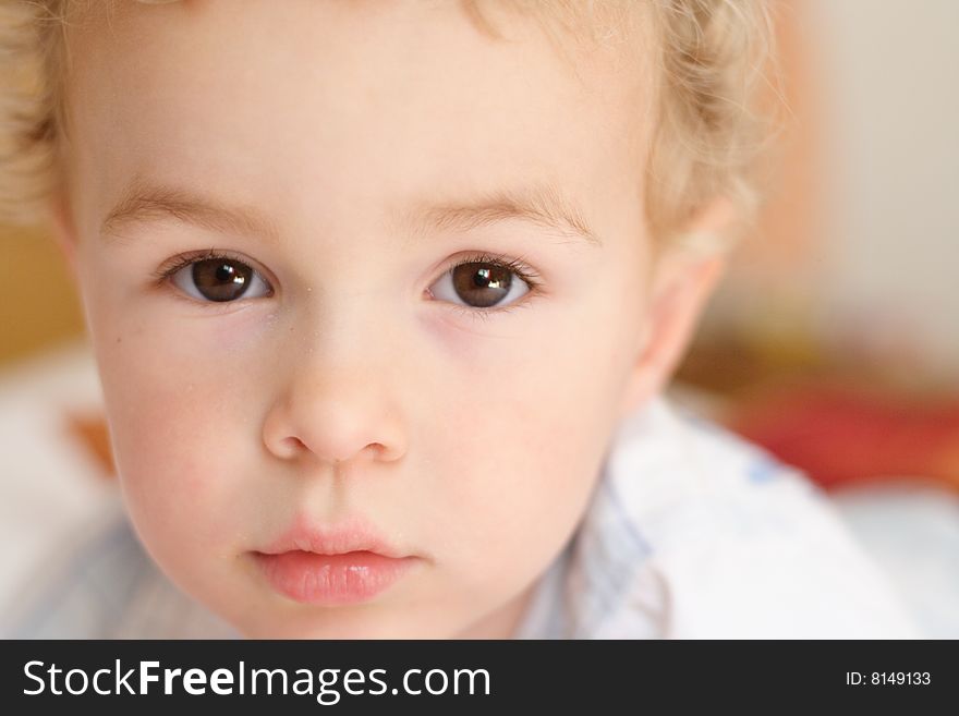 Kid staring at the camera with interogative expression. Kid staring at the camera with interogative expression