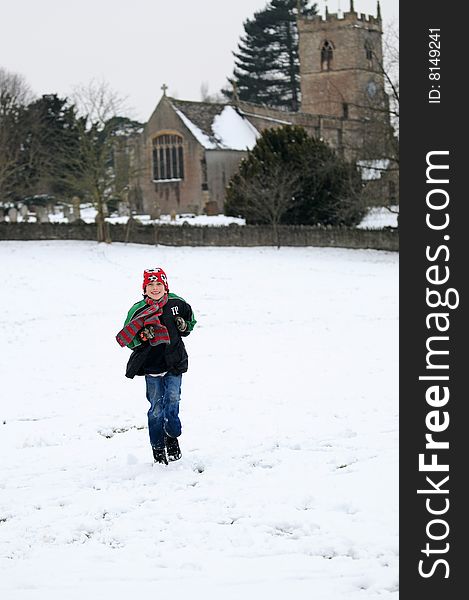 Portrait of boy running in the snow