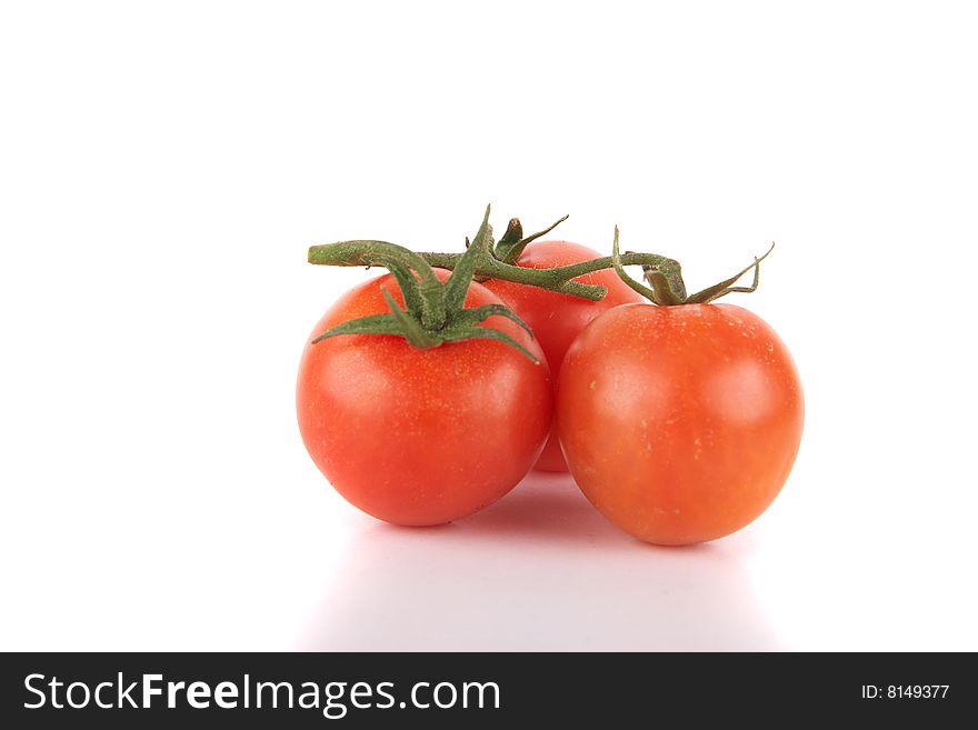 Macroshot of a bunch of tomatoes. Isolated over white background. Lot of copyspace. Macroshot of a bunch of tomatoes. Isolated over white background. Lot of copyspace.