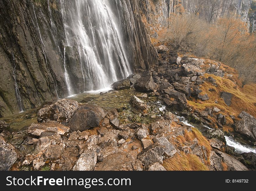 The beautiful waterfall in the forest, autumn (long exposure)