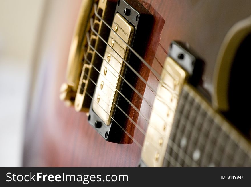 Close up of electric Guitar with golden coloured bridge