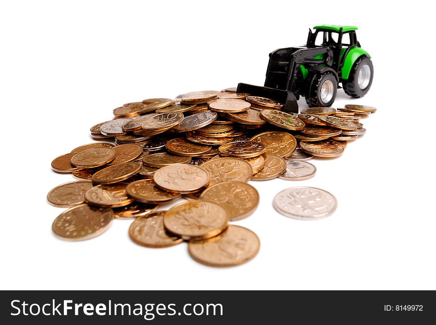 Green tractor raking up coins