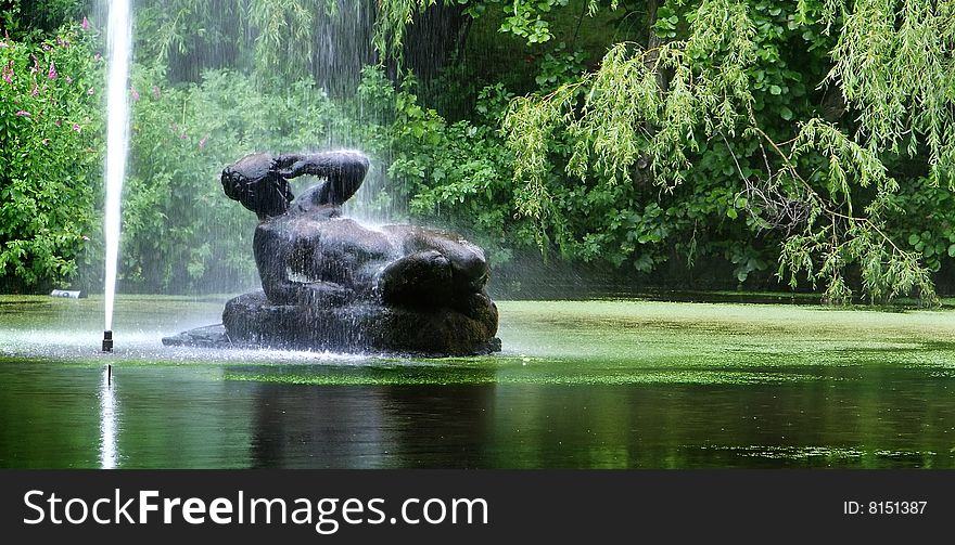 Fountain and sculpture of woman in park (Prague, Czech Rep.)
