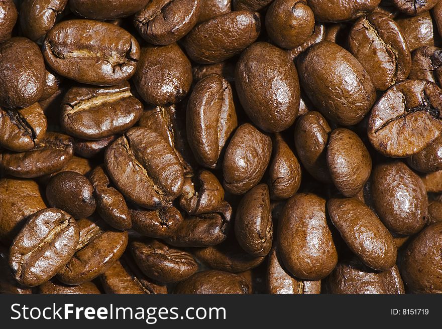 Fresh brown coffee beans background. Full frame.