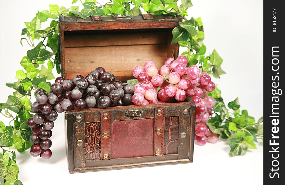 An array of grapes layed in a small chest. An array of grapes layed in a small chest