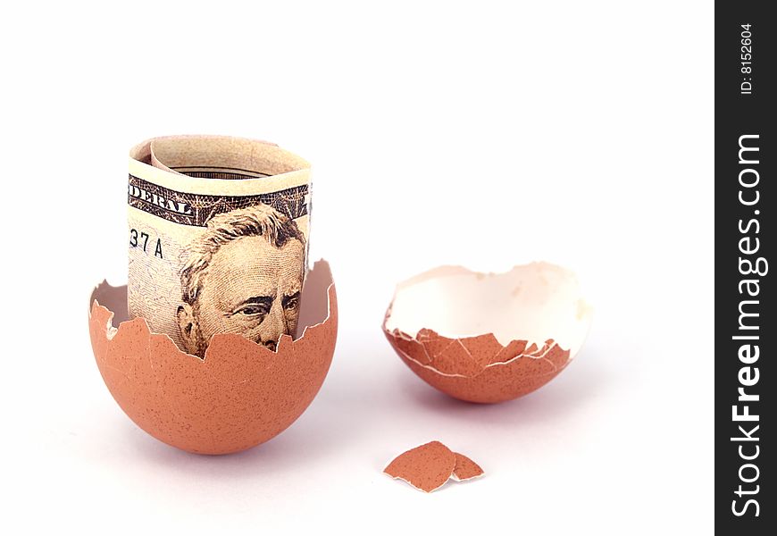 US dollar bank note inside of cracked egg. US dollar bank note inside of cracked egg